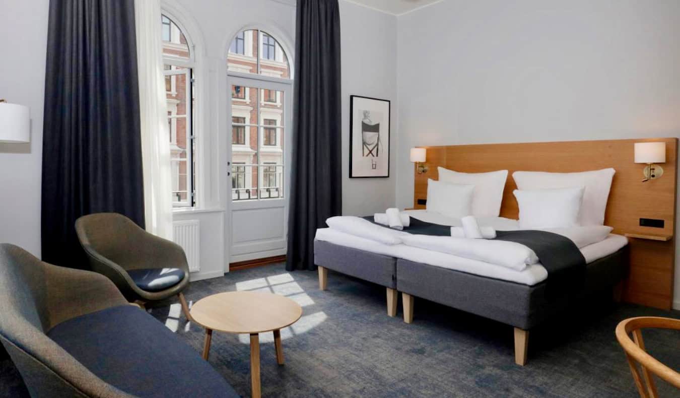 A large bed in a spacious hotel room at Hotel Bethel in Copenhagen, Denmark