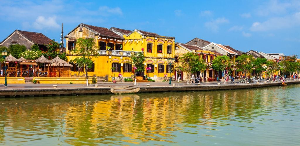 hanoi housing, yellow buildings set beside a river