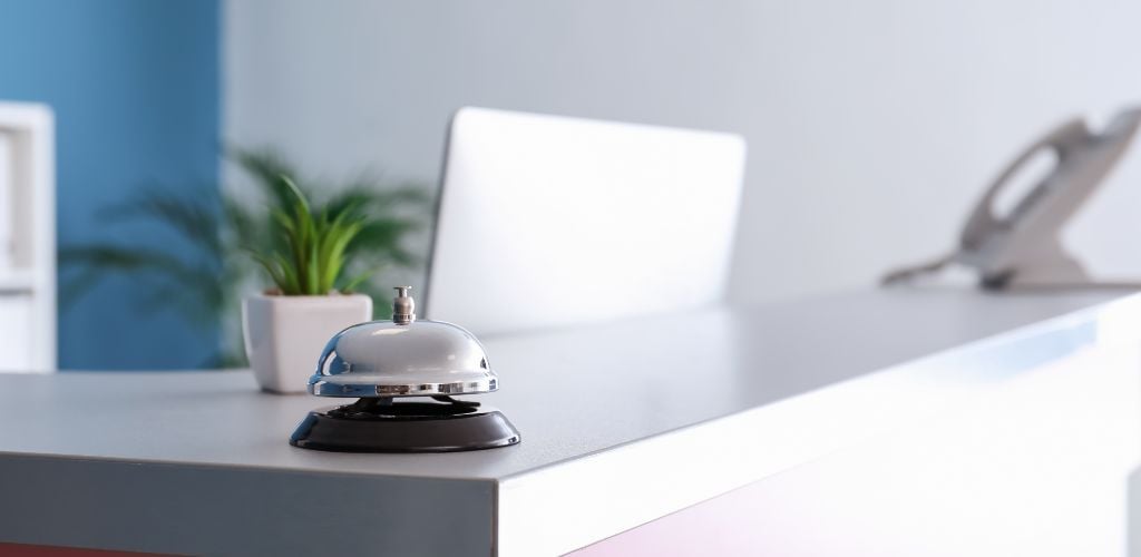 reception desk with bell and phone